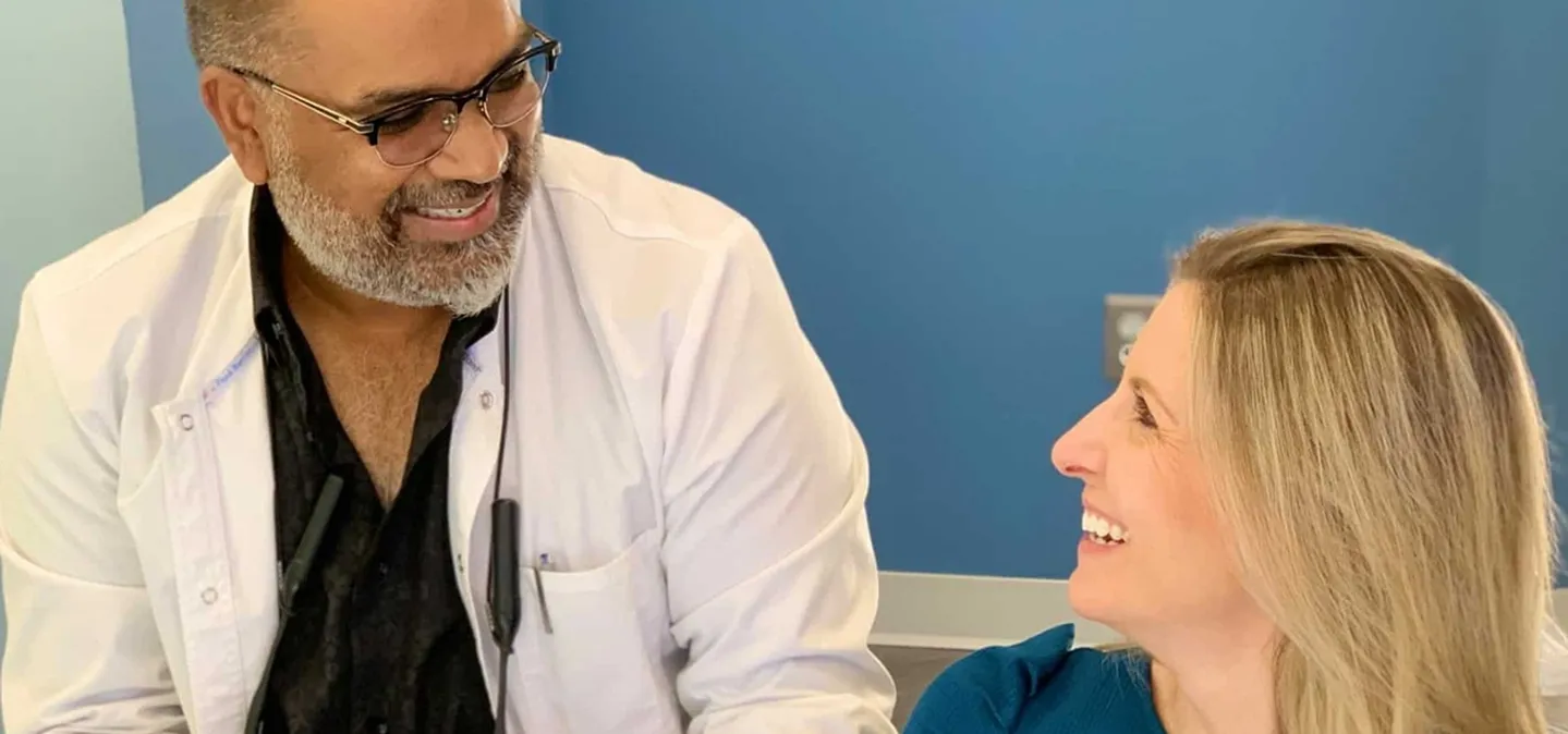 Dr. Enjati consulting with a patient about cosmetic dentistry